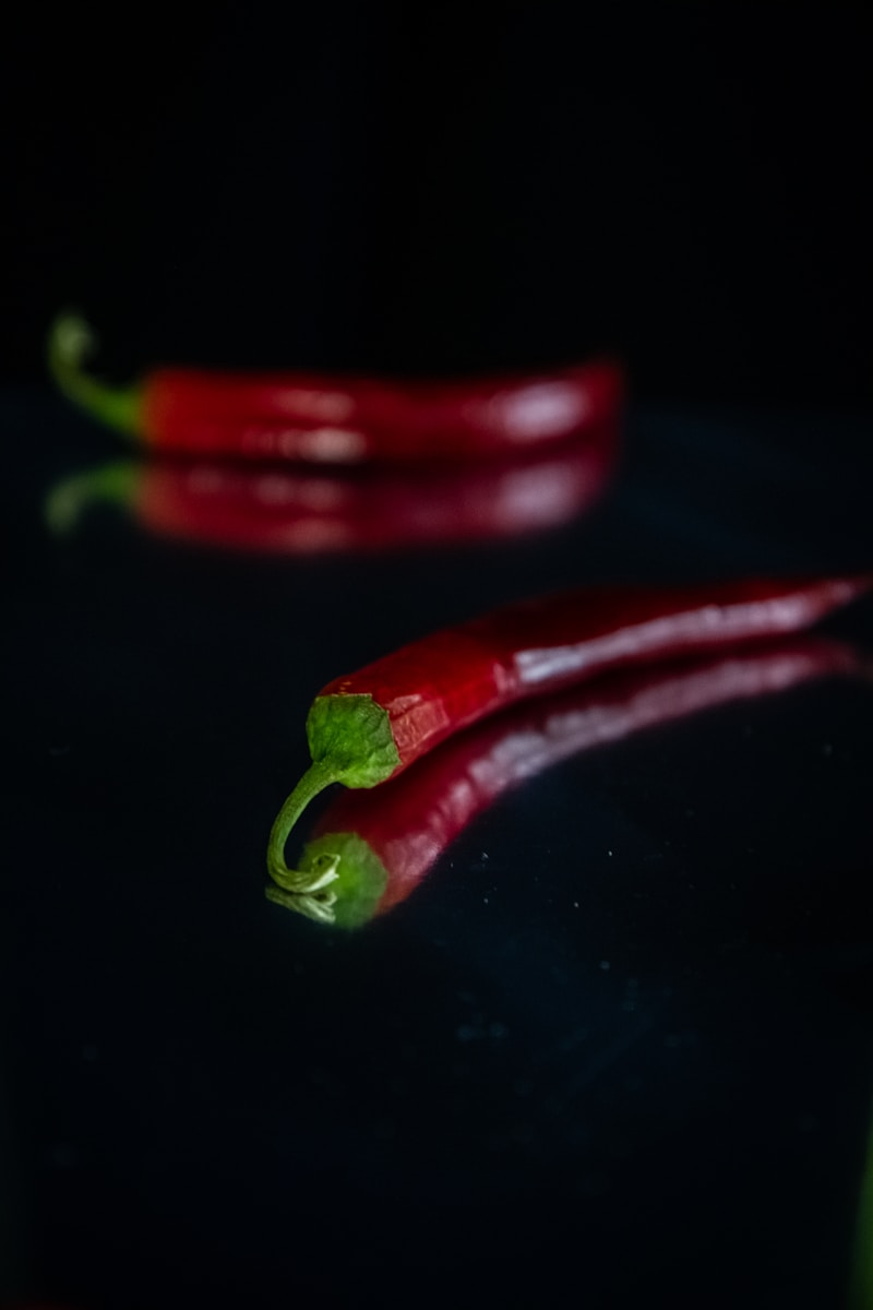 red chili pepper on black surface